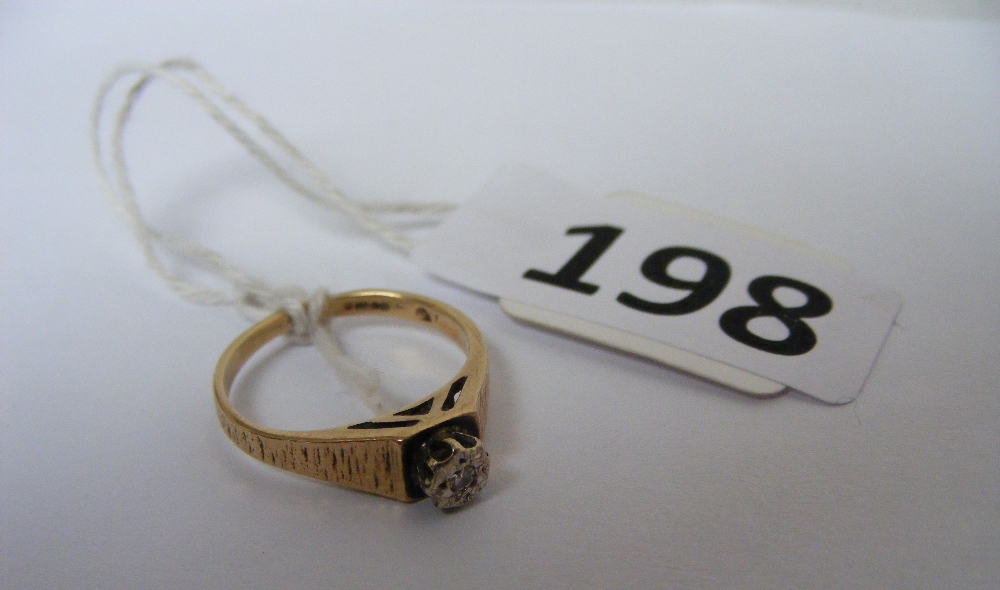 A gold ring set with a diamond weighing