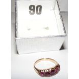 A 9ct gold ring set with five amethyst s