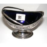 A fine early Georgian sterling silver sugar basket with a cobalt blue glass liner, silver weight