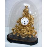 A French gilt metal mantle clock in glass dome.