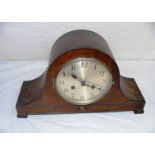 An oak mantle clock in the "Napoleon Hat" shape, appears to be in a ticking order, but comes without