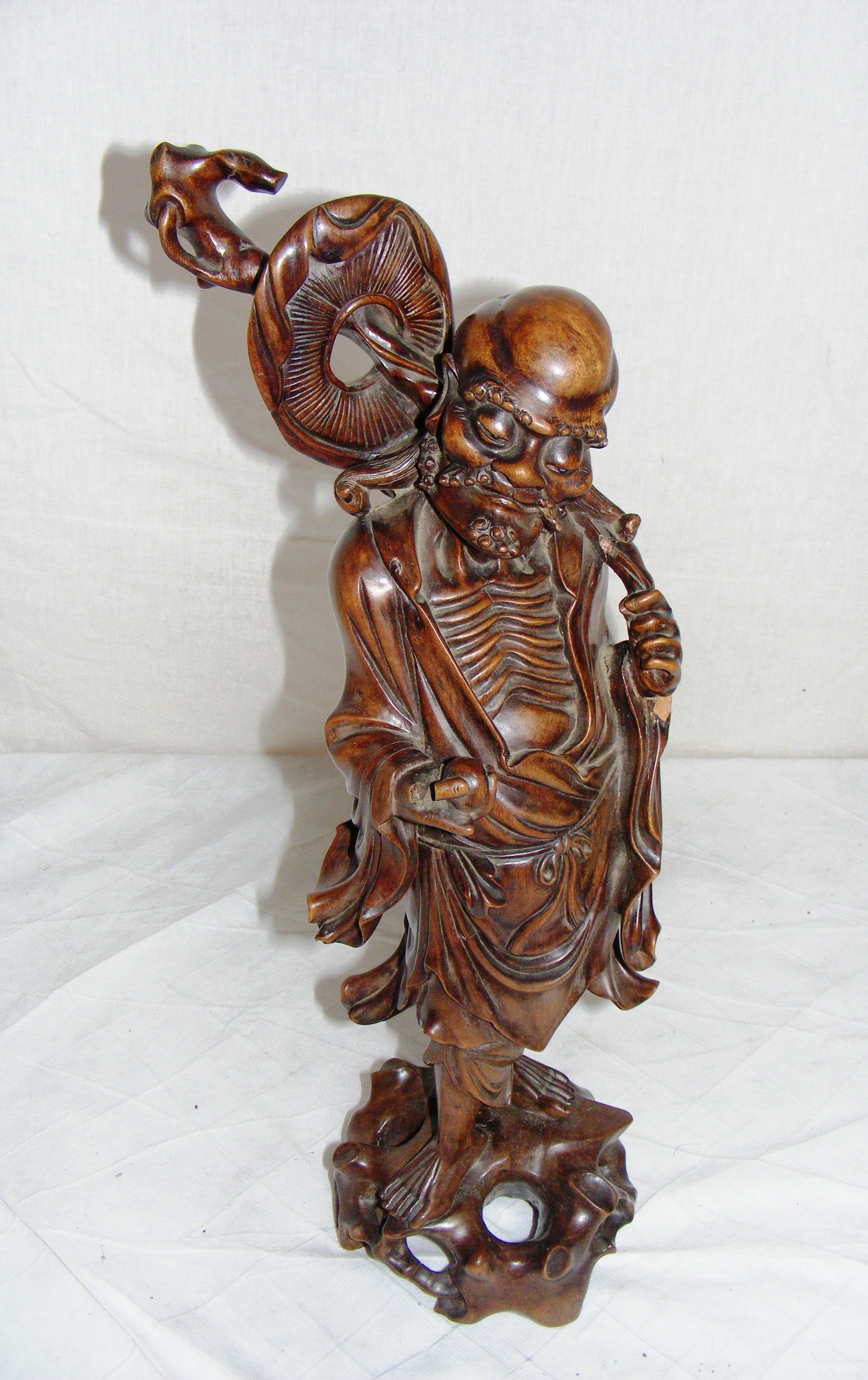 A Chinese hardwood figurine.