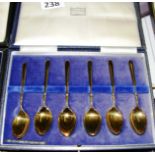 A cased set of sterling silver gilt spoons with hallmarks.