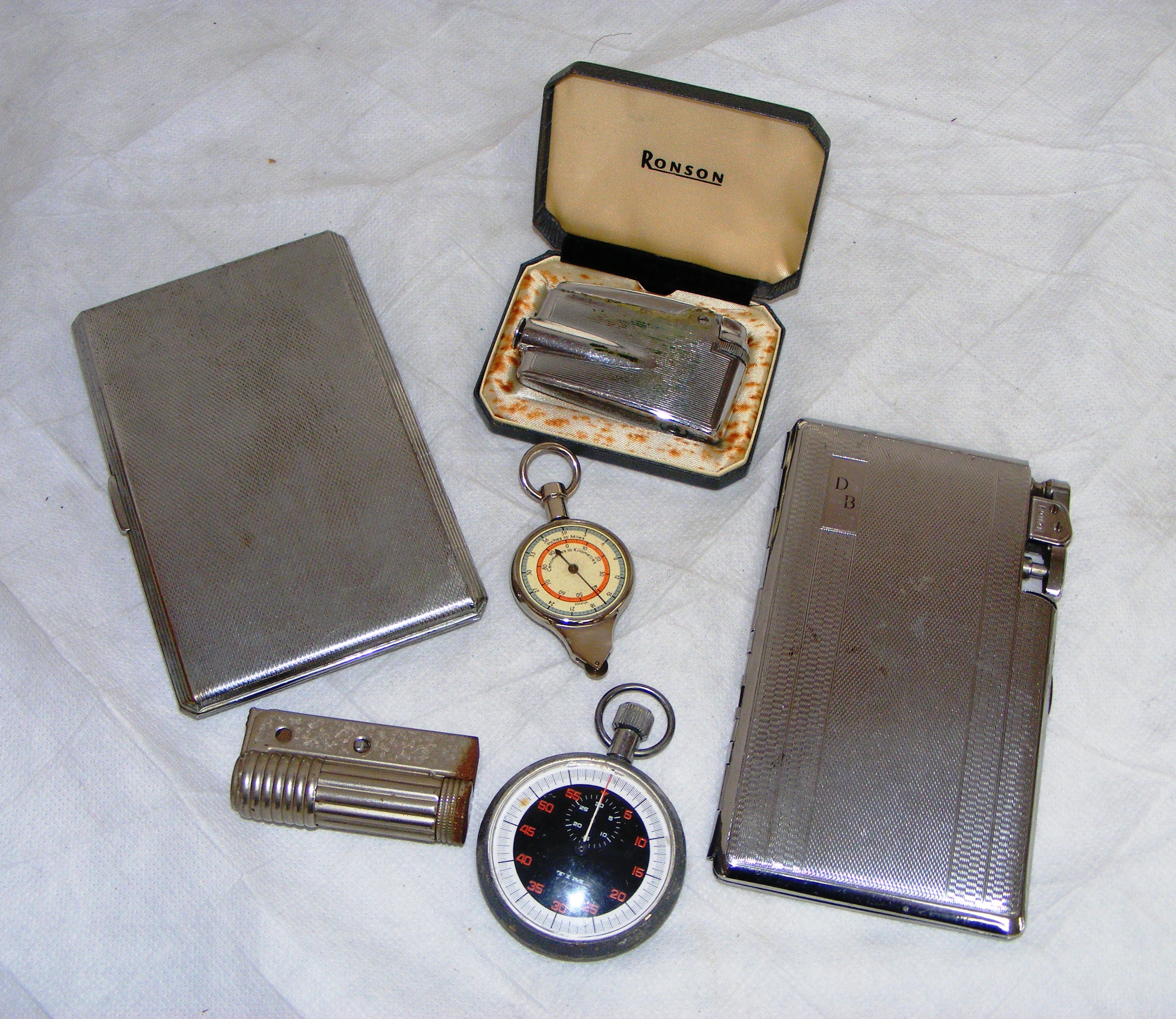 A selection of cigarette cases & vintage stopwatch. CONDITION REPORT: Note: we do not offer an in