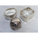 Two sterling silver napkin rings & a silver walking cane topper, combined weight 72.3 grams.