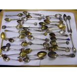 A large quantity of sterling silver spoons, some gold on sterling silver, some enamel,