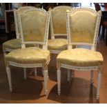 Suite de quatre chaises style Louis XVI, bois laqué et doré, garniture de soie jaune à motifs