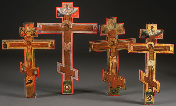 A GROUP OF FOUR RUSSIAN ICON CRUCIFIXES, 19TH CENTURY. Of varying sizes and each painted with the