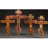 A GROUP OF FOUR RUSSIAN ICON CRUCIFIXES, 19TH CENTURY. Of varying sizes and each painted with the
