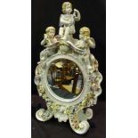 A Porcelain Table Mirror with Putti Surm