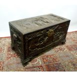 An Oriental Hardwood Chest, carved in re