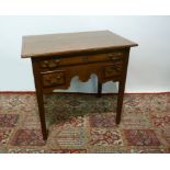 A George III Oak Lowboy, the moulded top