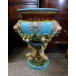 A Minton Majolica Large Pedestal Jardiniere decorated in relief with lion mask bows and swags,