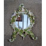 A Dresden Table Mirror decorated in relief with foliate encrusted decoration and putti,