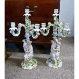 A Pair of Dresden Porcelain Candelabrum each with a figural centre column upon a shaped base,