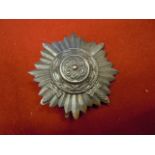 WWII German Ostvolk 1st Class. In bronze with crossed swords. Pin back. VF