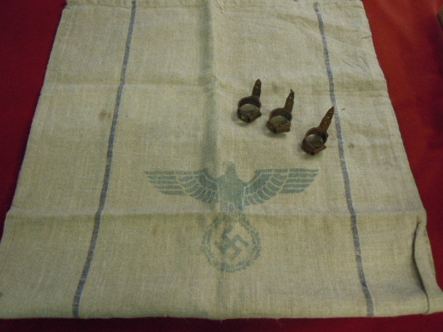 WWII German Food Sacks with Eagle stamp and three Booby Trap clamps as used to fix Stick Grenades to