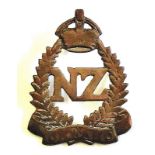 New Zealand Cap Badge:- 2nd New Zealand Expeditionery Force, KC, brass.  A wreath of ferns 'N.Z.' in