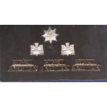 The Royal Angilan Regiment 1 chrome & gilt cap badge pair collar badges of the 1st Norfolk Suffolk