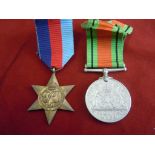 World War II pair of British medals  a 1939 - 1945 Star and a Defence Medal with their original