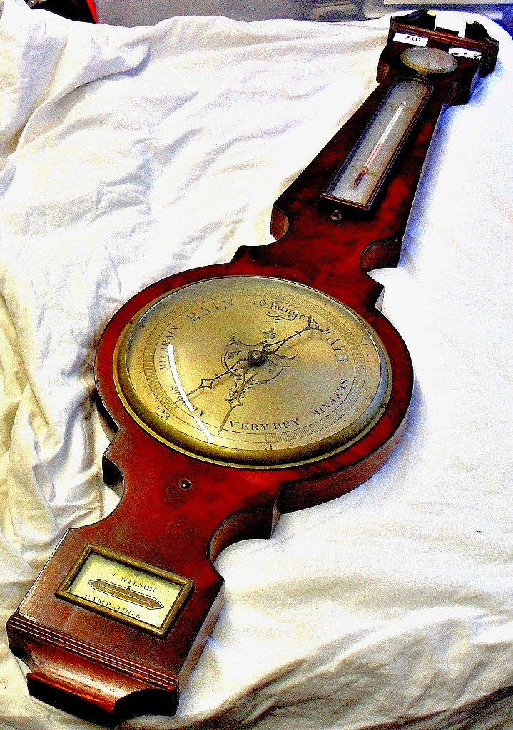 A good quality, 19th C, flame mahogany banjo barometer with swan neck pediment and brass finial.