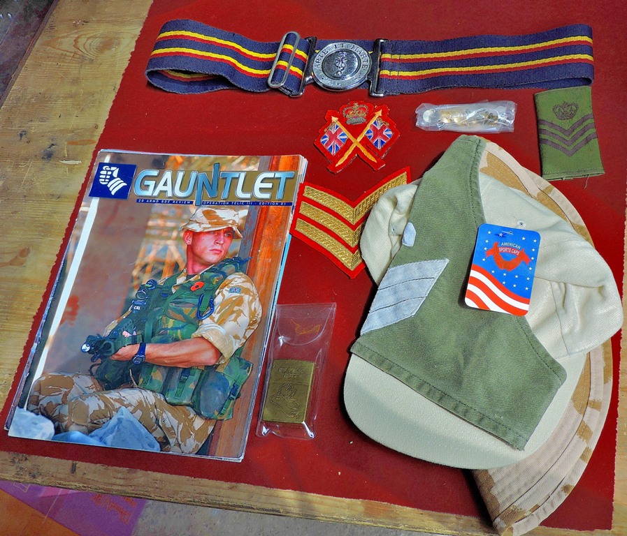 A box of assorted Gulf war memorabilia including: Two caps, Gauntlet Magazines, Op-Telic Zippo,