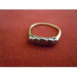 18ct Gold Ring  With platinum mount of four stones (one missing).  (Worn.)