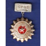 North Vietnamese Soldier to be emulated badge with 1965 clasp. Good badge