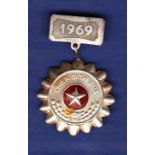 North Vietnamese Soldier to be emulated badge with 1969 clasp. Good badge