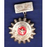 North Vietnamese Soldier to be emulated badge with 1961 clasp. Good badge