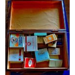 Cigarette Packets  In a light vintage wooden small suitcase.