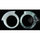 TWO JADE SADDLE RINGS. 20th century, China. SIZE: Each approx. 19.05 mm. CONDITION: Very good.
