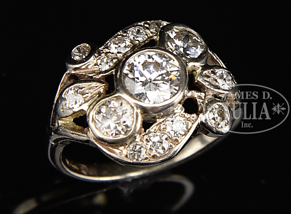 14KT WHITE GOLD DIAMOND LADY'S RING. The center diamond surrounded by 13 various sized diamonds.