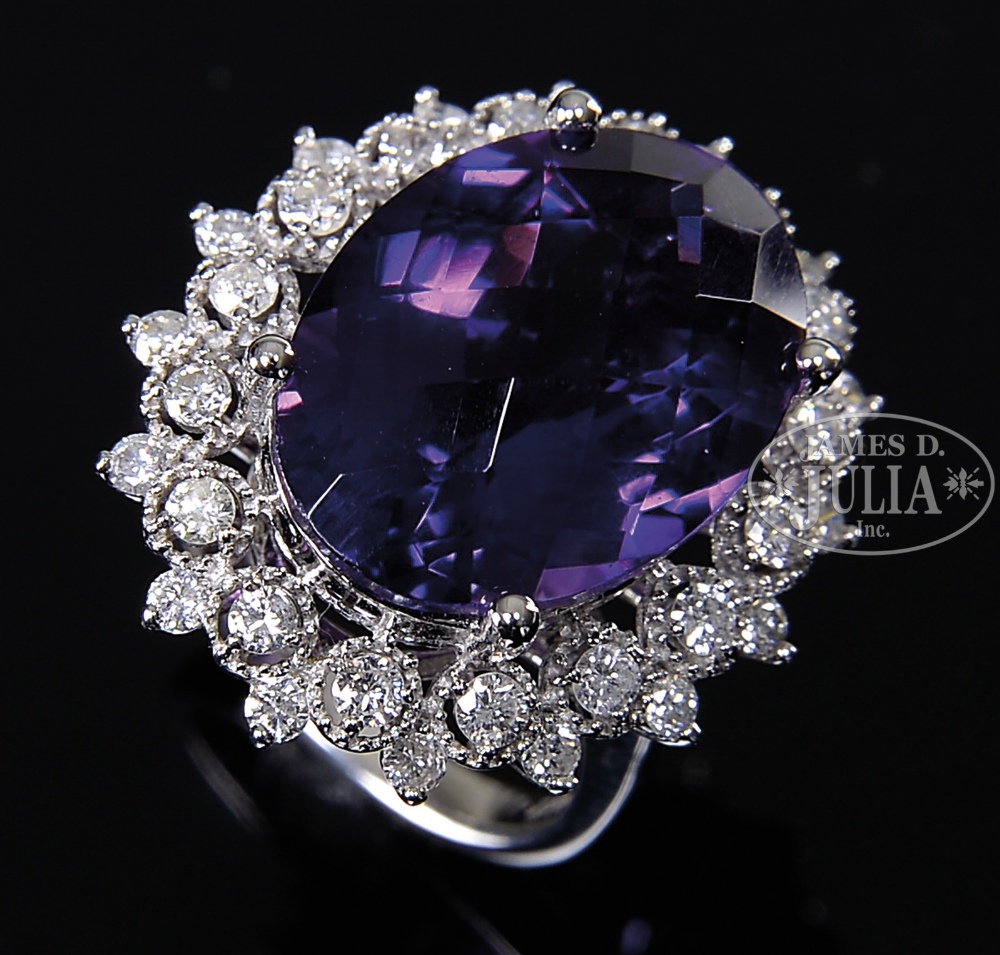 14KT WHITE GOLD AMETHYST AND DIAMOND LADY'S RING. A large oval amethyst is surrounded by a ring of