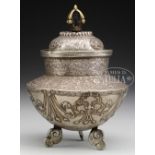 SILVER RITUAL POT. 19th century, Tibet. Raised on three cloud legs, the body decorated with four