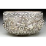 LARGE REPOUSSE SILVER BOWL. Circa 1900, Burma. Raised on three knob feet, the body with multiple