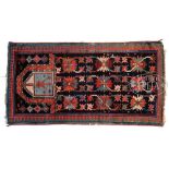 SEMI-ANTIQUE CAUCASIAN PRAYER RUG. Having a dark cobalt field with multi-colored repeating crab