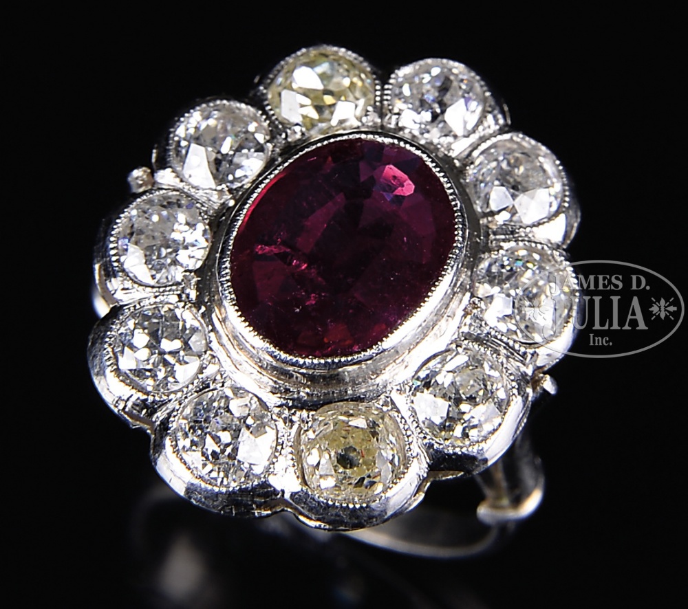 DIAMOND AND RUBY LADY'S RING. The white metal unmarked, probably white gold or platinum. The oval