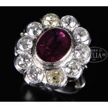 DIAMOND AND RUBY LADY'S RING. The white metal unmarked, probably white gold or platinum. The oval