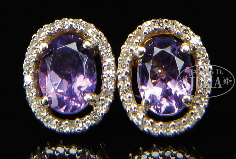 14KT DIAMOND AND AMETHYST PEIRCED EARRINGS. The posts marked "14K". The light oval amethyst