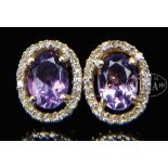 14KT DIAMOND AND AMETHYST PEIRCED EARRINGS. The posts marked "14K". The light oval amethyst