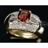 14KT YELLOW GOLD DIAMOND AND ORANGE STONE LADY'S RING. The wide ring having 28 full cut diamond