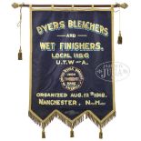 EARLY 20TH CENTURY PAINTED MANCHESTER NH TRADE BANNER WITH LEDGER BOOKS. The banner having a gold