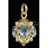 INTERESTING BLUE STONE 18KT PENDANT. The pendant marked "750". Lantern form with open center