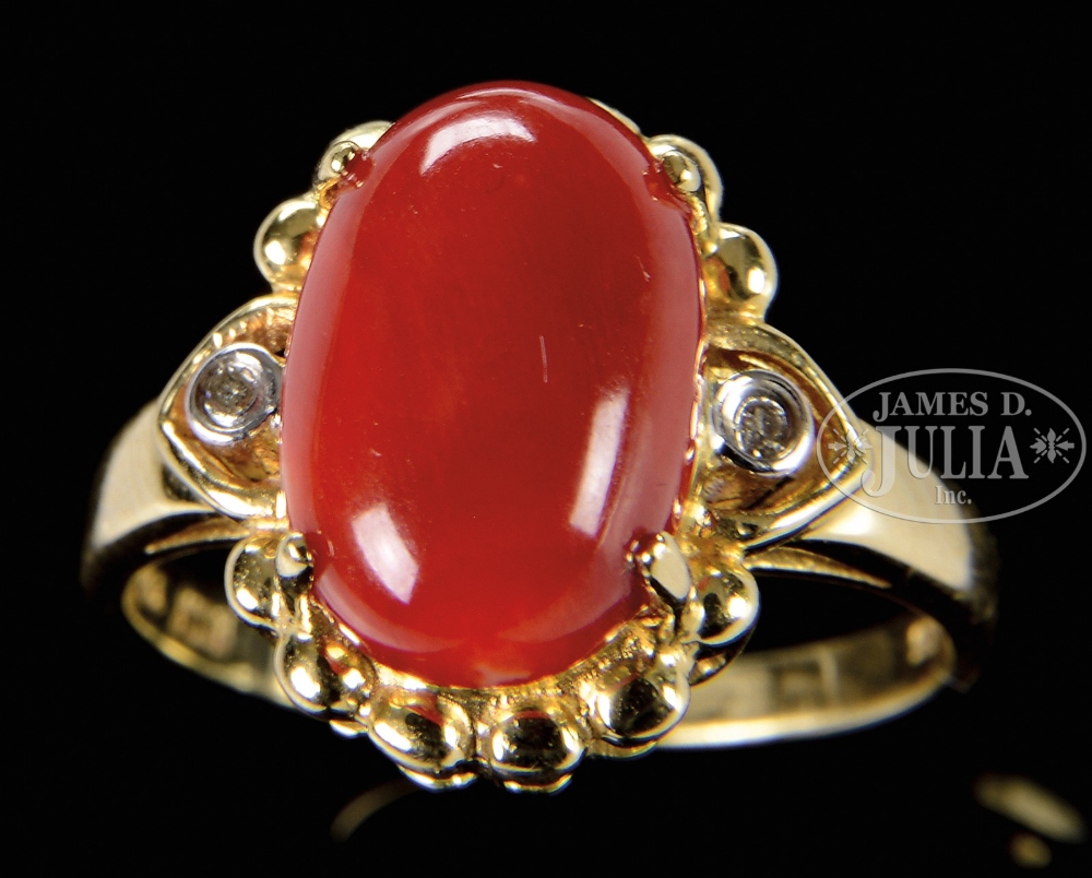 MEDIUM BLOOD CORAL GOLD RING. China. Coral cabochon a very deep red. Stamped "18k" inside band.