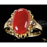 MEDIUM BLOOD CORAL GOLD RING. China. Coral cabochon a very deep red. Stamped "18k" inside band.