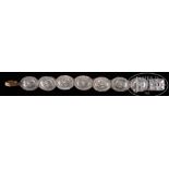 LARGE NAVAHO COIN SILVER SECOND PHASE CONCHO BELT. Circa 1910. Comprised of seven conchos on a