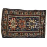 ANTIQUE SHIRVAN RUG. Late 19th Century. Three aligned crab medallions on a midnight blue field