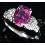 RUBY DIAMOND AND PLATINUM LADY'S RING. The center oval cut light ruby having 6 diamond melees on