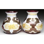 PAIR OF BOHEMIAN GLASS VASES. Late 19th, early 20th Century. Each cranberry squat vase with white